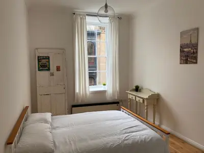 a bedroom with a bed and a window at Lovely 1-Bed Apartment in Glasgow Merchant City in Glasgow