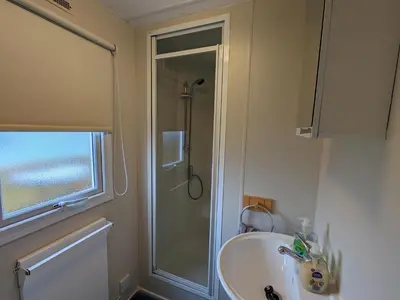 a bathroom with a shower and a sink at Loch Heron View in Newton Stewart
