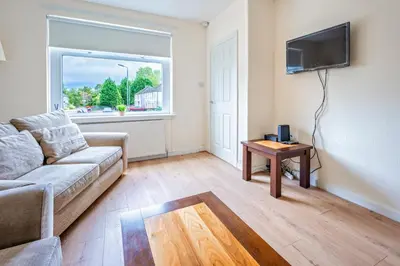 a living room with a couch and a table at Millfield House - Cosy 2 bed house in Motherwell in Motherwell