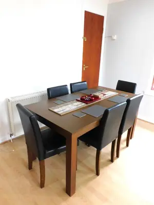 a dining room table with black chairs and a keyboard at Charming 2 bed apt close to City and SEC Hydro in Glasgow