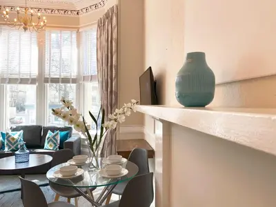 a living room with a table and a vase on a counter at The Buckingham Studio in Glasgow