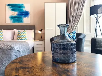 a glass vase sitting on a table in a living room at The Buckingham Studio in Glasgow