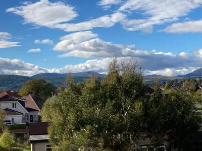 a view of a town with mountains in the distance at Aspen Apartment in Helensburgh