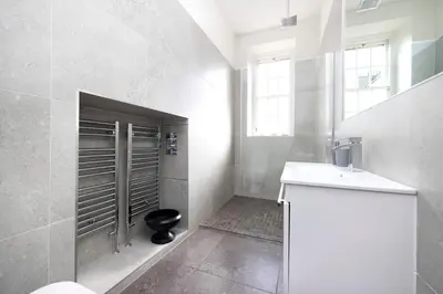 a bathroom with a toilet and a sink at JOIVY Contemporary Flat in the New Town in Edinburgh