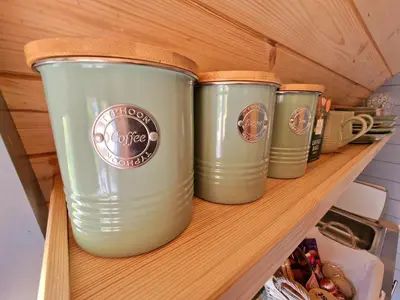 four green coffee cups sitting on a shelf at Bothan Creag Sobhrag in Ballachulish