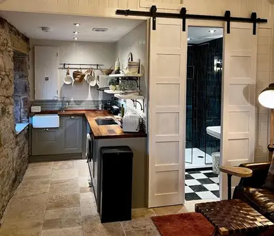 a kitchen with a counter top in a room at Charming stone Bothy at Loch Lomond in Luss