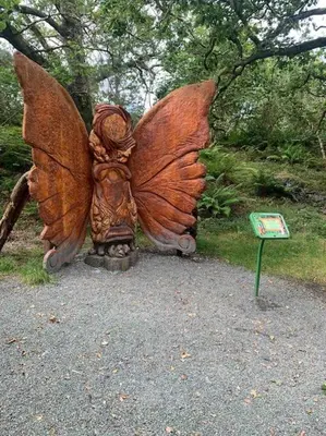 a statue of a butterfly statue in a park at Charming stone Bothy at Loch Lomond in Luss