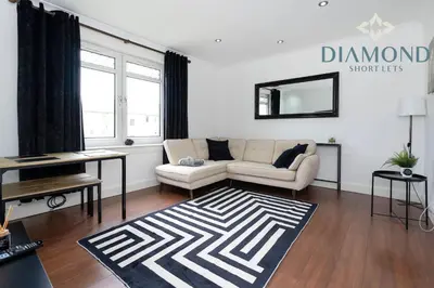 a living room with a couch and a table at Cosy 2 Bed Apt West End Edinburgh FREE PARKING in Edinburgh