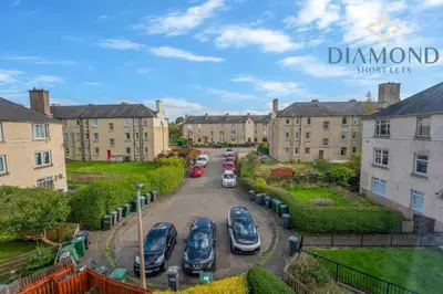 a group of cars parked in a parking lot in front of buildings at Cosy 2 Bed Apt West End Edinburgh FREE PARKING in Edinburgh