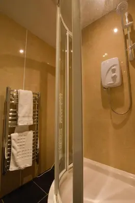 a bathroom with a shower with a glass shower door at Cologin Farmhouse in Oban
