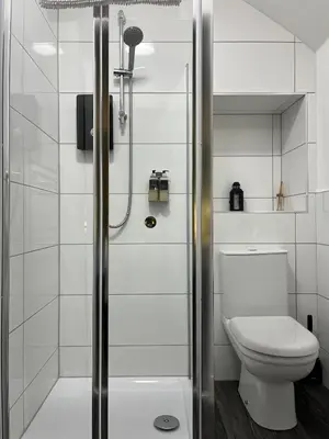 a bathroom with a shower and a toilet at The Rhu Inn in Rhu