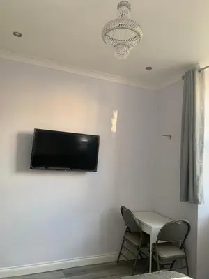 a room with a flat screen tv on a wall at Ibrox Argyll Inn in Glasgow