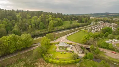 an aerial view of a house in a park next to a river at The Corran in Lochgilphead