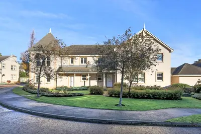 a large white house with a circular driveway at JOIVY Modern Flat with Free Parking in Edinburgh
