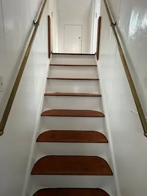 a stair case in a house with wooden stairs at 3 bedroom cosy cottage in Lamlash, Isle Of Arran in Lamlash