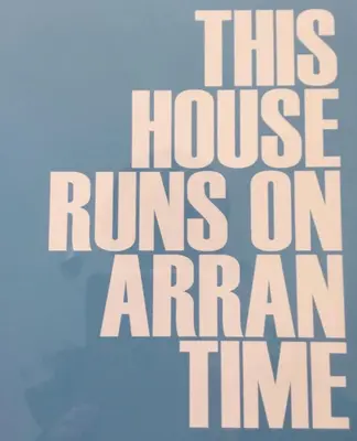 a sign that reads this house runs on aran time at 3 bedroom cosy cottage in Lamlash, Isle Of Arran in Lamlash
