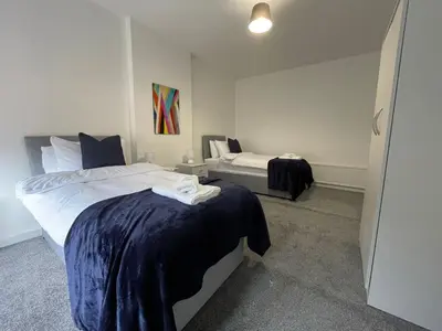 a bedroom with two beds in a room at Cardonald House in Glasgow