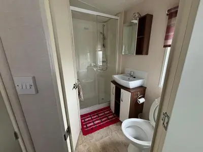 a bathroom with a shower and a sink and a toilet at Coyles retreat in Stranraer