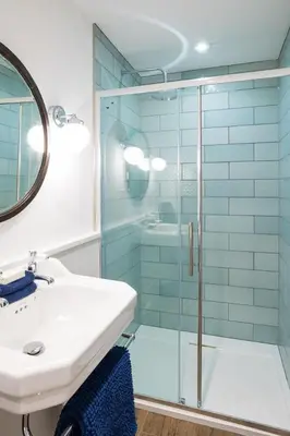 a bathroom with a glass shower and a sink at Grobdale Byre in Gatehouse of Fleet