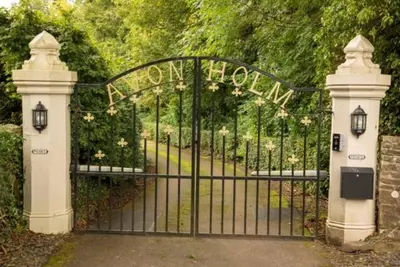 a gate to a garden with a sign that reads town house at Unique Orchard Lodge for couples with hot tub in Strathaven
