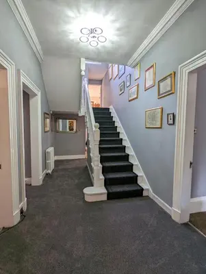 a hallway with a staircase in a house at Bonnyside House in Bonnybridge