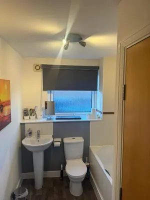 a bathroom with a toilet and a sink at Ferry Gait Apartments in Edinburgh