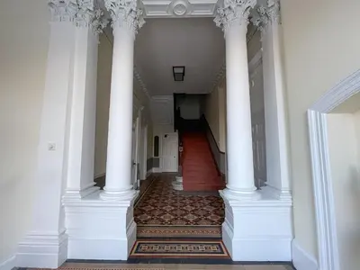 a hallway with white columns in a building at 1 Bed Character Filled Glasgow Apartment in Glasgow