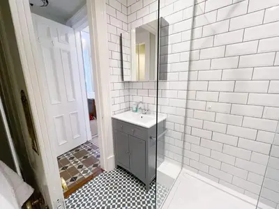 a bathroom with a sink and a glass shower at 1 Bed Character Filled Glasgow Apartment in Glasgow