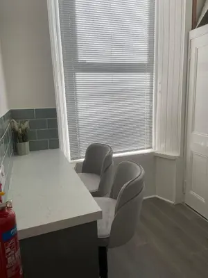 a kitchen with two chairs and a table and a window at The Princess Flat, Helensburgh. in Helensburgh