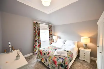 a bedroom with a bed and a window at The Old Manse in Ayr