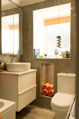 a bathroom with a sink and a toilet and some donuts at The Nest - small double room nr Glencoe in Ballachulish