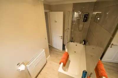 a bathroom with a shower and a bath tub at The Nest - small double room nr Glencoe in Ballachulish