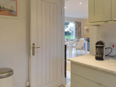 a kitchen with a door leading to a dining room at Whitehouse Studio in Roslin