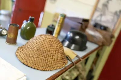 a straw hat sitting on a counter in a kitchen at Cultybraggan Hut 36 in Mill of Fortune