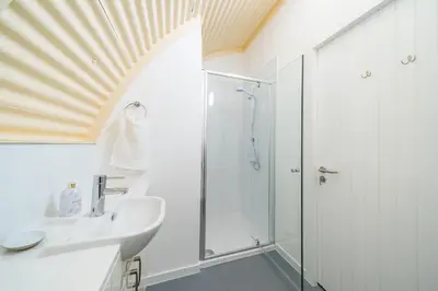 a bathroom with a shower and a sink at Cultybraggan Hut 35 in Comrie