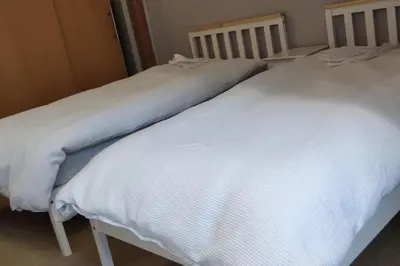 two white beds sitting next to each other at West End & EICC with Parking in Edinburgh