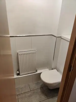 a bathroom with a white toilet and a radiator at West End & EICC with Parking in Edinburgh
