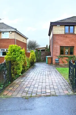 a brick driveway in front of a brick house at A cosy house near the city centre in Glasgow