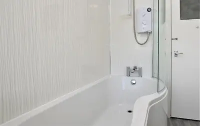 a white bath tub in a bathroom with a shower at Anchor View in Ardrishaig