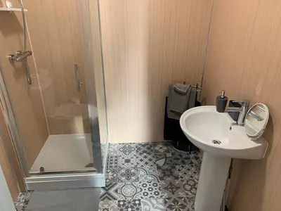 a bathroom with a sink and a shower at Nelson st (MAYBOLE) in Largs