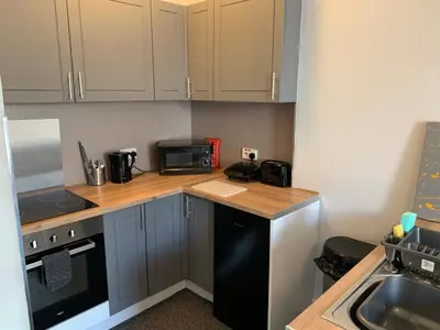 a kitchen with a black refrigerator and a microwave at Nelson st (MAYBOLE) in Largs