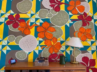 a mural of flowers on a wall with a lamp at Lovely flat overlooking the Clyde in Gourock