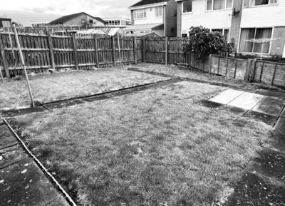 a yard with a fence in front of a house at Glenbervie - Beautifully refurbished, self-contained apartment in Fife