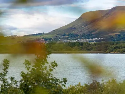 a view of a lake with mountains in the background at Chalet Loch Side Lodge 8 by Interhome in Kinross
