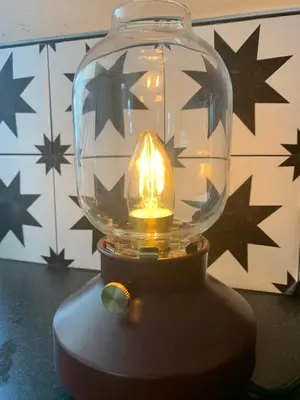 a glass jar with a candle in it on a table at This must be the place - Arran, Lamlash in Lamlash