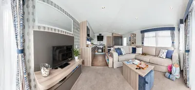 a living room with a couch and a tv at Machrihanish Holiday Park in Campbeltown