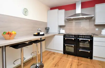 a kitchen with a black stove and a counter at Pedals and Paddles in Innellan