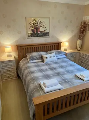 a bedroom with a bed with two towels on it at Stunning views in Lochgoilhead