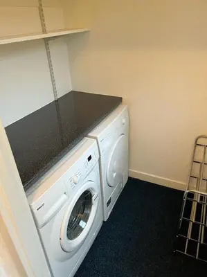 a laundry room with a white washer and dryer at Stunning views in Lochgoilhead