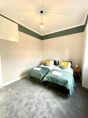 a bedroom with two beds and a ceiling at Stevenson Apartment in Alexandria